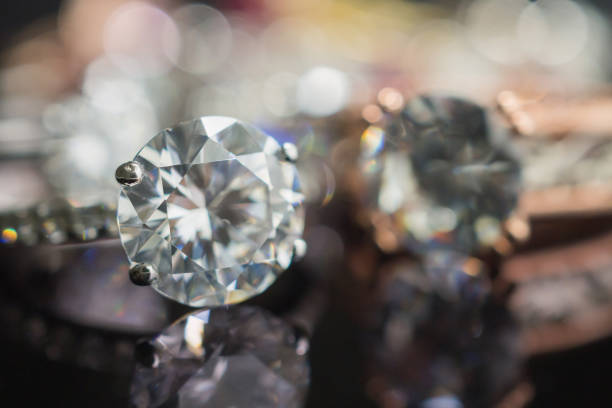 Jewelry wedding diamond rings on black background with reflection