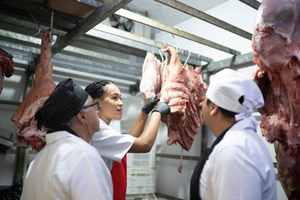 istock Butchers analyzing meat in a meat locker 1176910397