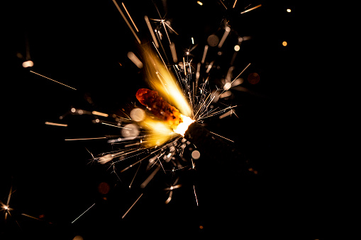 A closeup of a backyard fireworks sparkler
