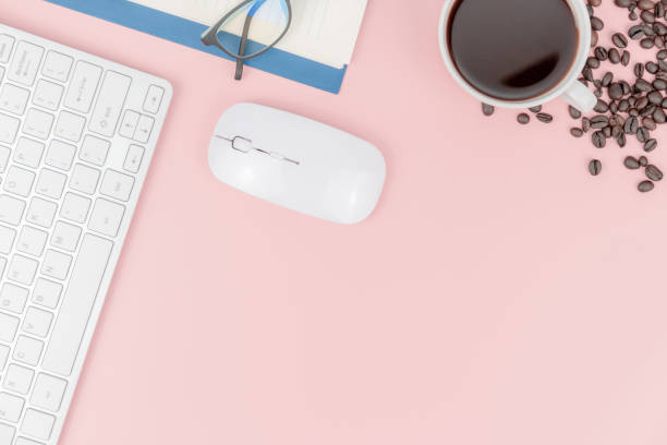 istock Top view with copy space of Coffee cup with coffee beans computer keyboard and mouse overhead on pink pastel background, Flat lay concept 1176913570