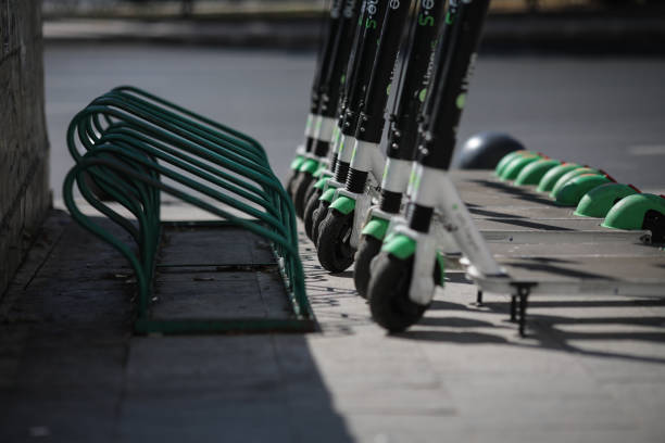 Lime electric scooters one next to another in downtown Bucharestt. Bucharest, Romania - September 22, 2019: Lime electric scooters one next to another in downtown Bucharest. lime scooter stock pictures, royalty-free photos & images