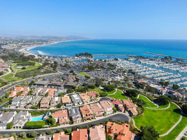 Aerial view of Dana Point Harbor town and beach Aerial view of Dana Point Harbor town and beach. Southern Orange County, California. USA dana point stock pictures, royalty-free photos & images
