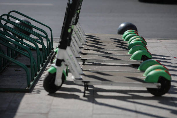 Lime electric scooters one next to another in downtown Bucharestt. Bucharest, Romania - September 22, 2019: Lime electric scooters one next to another in downtown Bucharest. lime scooter stock pictures, royalty-free photos & images