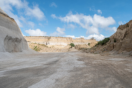 Sand quarry landscape with vivid blue sky and clouds at sunny day
