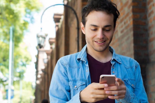 istock Young man typing on his phone. 1176921774
