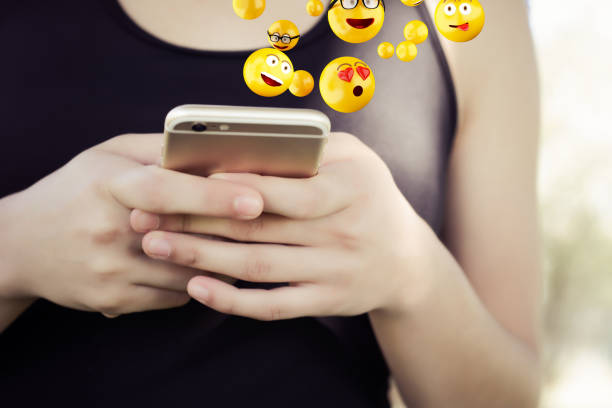 istock Woman using smartphone sending emojis. 1176921817