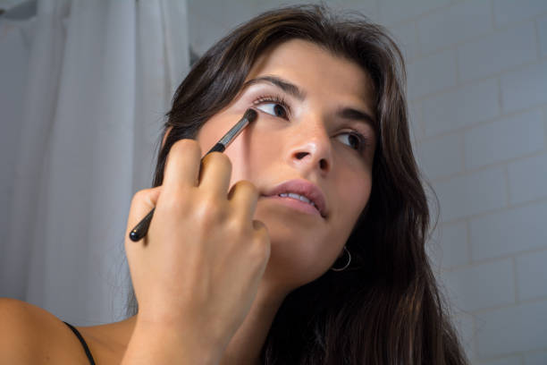 istock Woman applying make up in bathroom. 1176921900