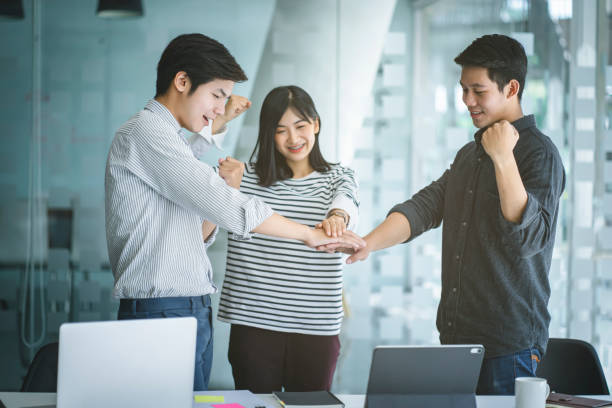 Business people put hands together. Teamwork and power successful meeting workplace concept. stock photo