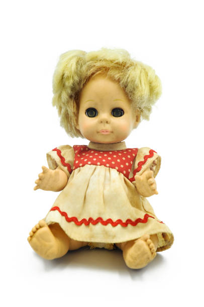 istock Vintage baby doll sitting on white background 1176925504
