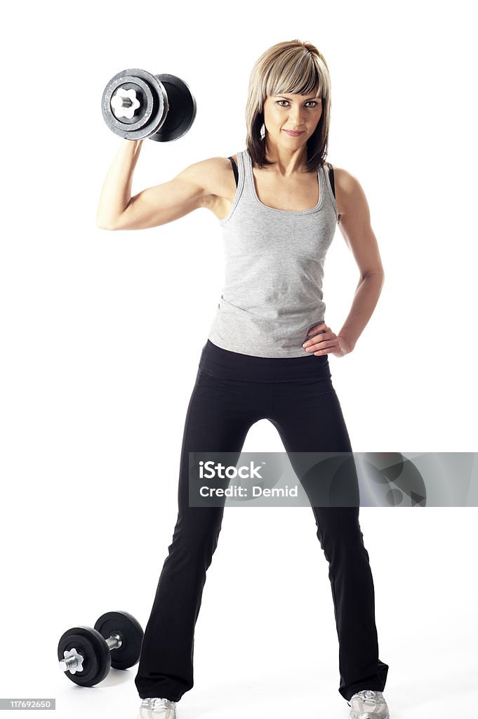 Sportswoman con manubri - Foto stock royalty-free di Abbigliamento sportivo