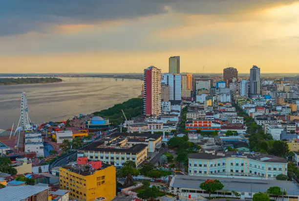 Cityscape of Guayaquil city at sunset with the Guayas river and skyscraper skyline, Guayaquil, Ecuador.