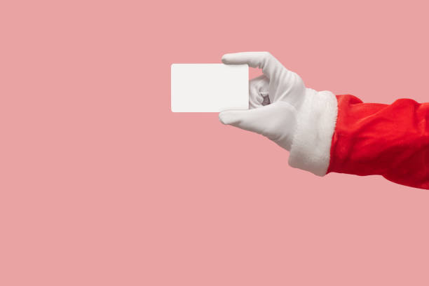 istock Santa Claus hand holding credit card. 1176939130