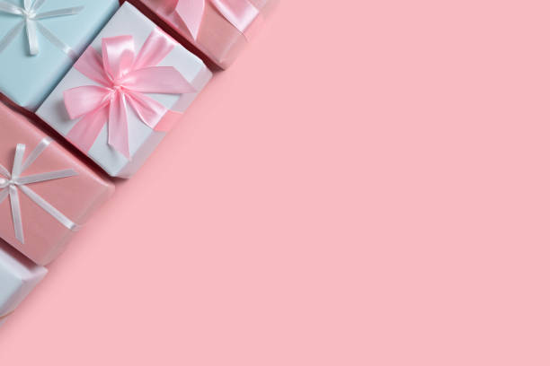 istock Colorful gift boxes at the corner on pink isolated background 1176939132