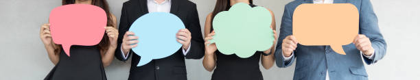 People are holding colorful Speech Bubbles. Group of Business People holding blank colorful Speech Bubbles. Banners, Panoramic, Web. announcement message photos stock pictures, royalty-free photos & images