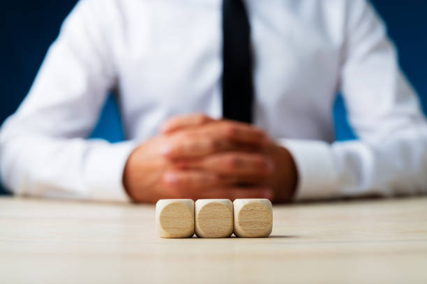 istock Three blank wooden dices in a row 1176939587