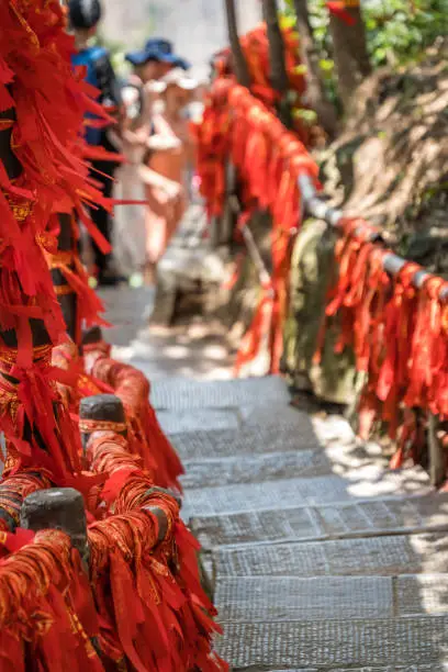 Photo of Red ribbons along trail in mountains in Zhangjiajie