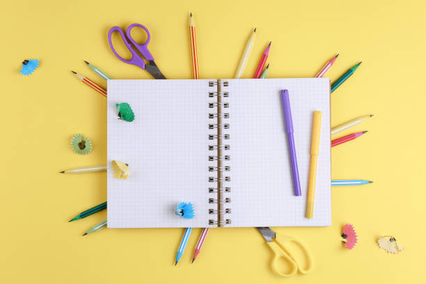 istock notebook on a yellow isolated background, office supplies 1176940559