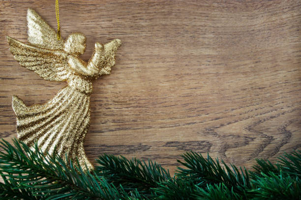 Christmas decoration glorious golden angels on wood background stock photo