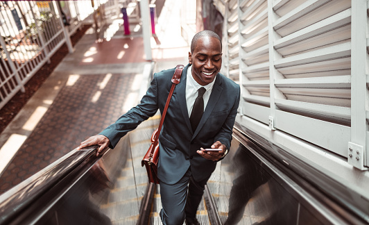 businessman walking on the escalator