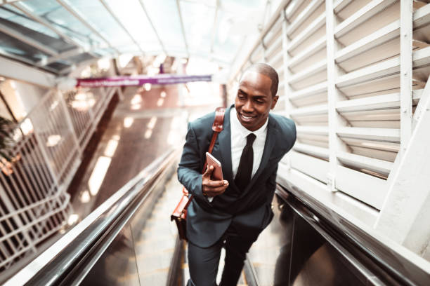 istock businessman walking on the escalator 1176946246