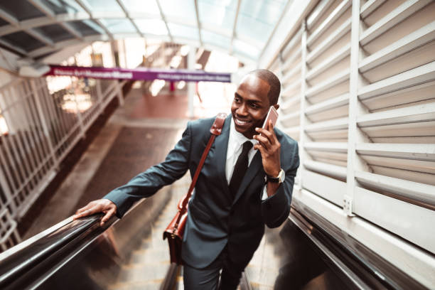 istock businessman walking on the escalator 1176946311