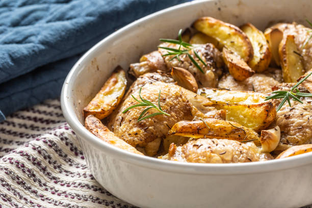 istock Chicken legs roasted with american potatoes in baking dish 1176947212