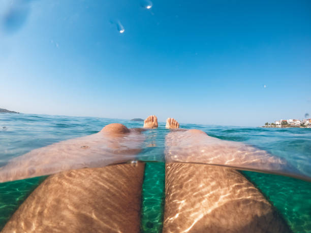 Young caucasian man snorkeling and having fun in the sea.