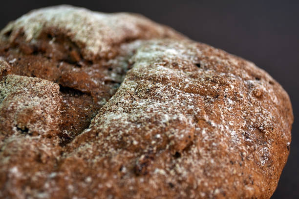 istock Whole grain rye bread, isolated on dark background. Macroshot 1176948526