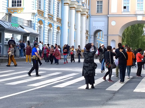 St. Petersburg, Russia - September 8, 2019: Groups of Chinese tourists in historical center of Pushkin (Tsarskoye Selo) near Imperial Catherine Palace. Suburbs of Petersburg. Large lines to the museum