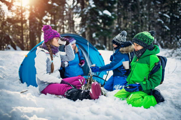 istock Mother and kids camping in winter forest 1176951246