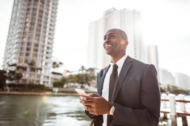 istock businessman text messaging walking on miami street 1176952433
