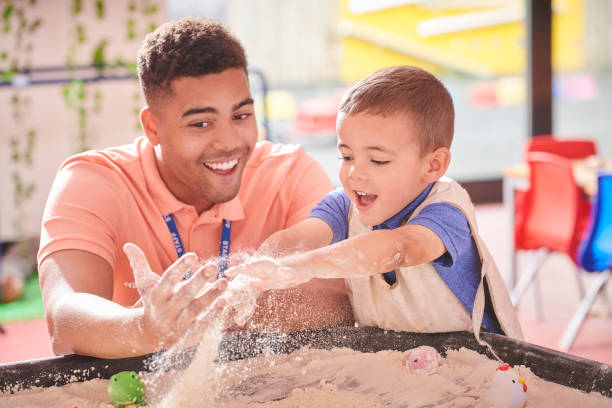 nursery sandpit nursery teacher with student teacher classroom child education stock pictures, royalty-free photos & images