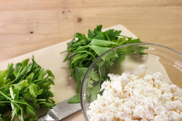 Fresh parsley with knife on wooden cutting board
