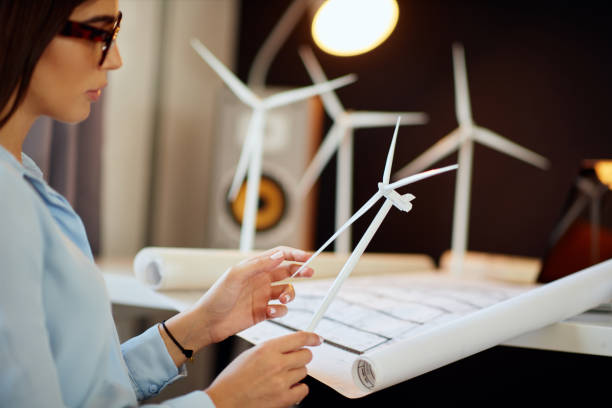 istock Buinesswoman holding windmill model. 1176956097