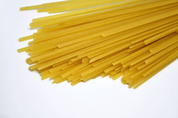 istock Raw Italian spaghetti pasta on white background. 1176956175