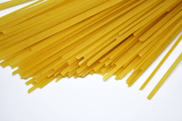 istock Raw Italian spaghetti pasta on white background. 1176956196