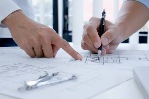 istock Colleagues interior designer Corporate Achievement Planning Design on blueprint Teamwork Concept with compasse. 1176956343