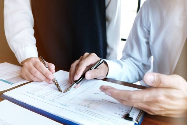 istock Businessman analyzing investment charts and pressing calculator buttons over documents. Accounting Concept. 1176957791