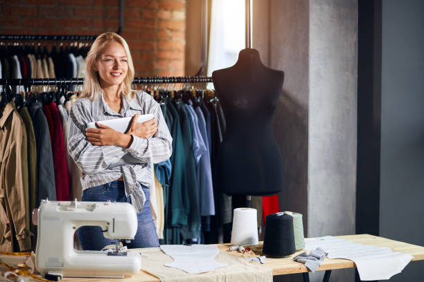istock cherrful blonde tailor hugging her laptop 1176958500