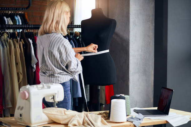 istock young tailor working with measuring tape 1176958688