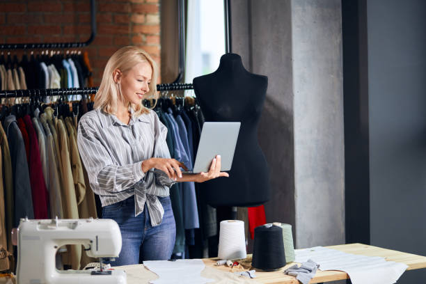 cheerful blonde woman surfing the net, browsing the internet, sending e-mail