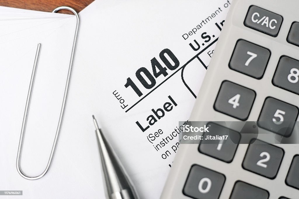 U.S. 1040 Tax Form With Pencil, Calculator and Paper Clip  Generic - Description Stock Photo
