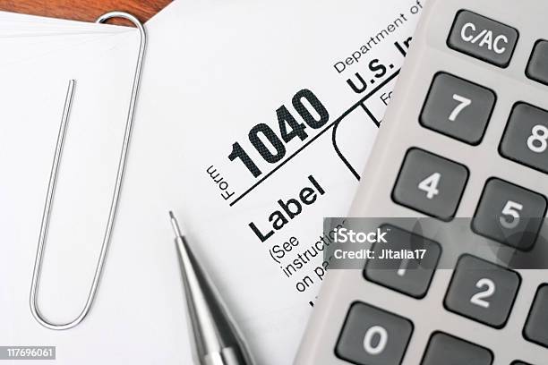 Us 1040 Tax Form With Pencil Calculator And Paper Clip Stock Photo - Download Image Now