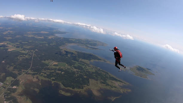 istock Skydiver falls through clear skies, aerial flight 1176961831