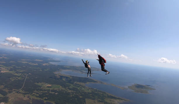 istock Skydivers fall through clear skies, aerial flight 1176962120