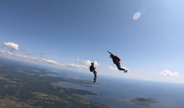 istock Skydivers fall through clear skies, aerial flight 1176962531