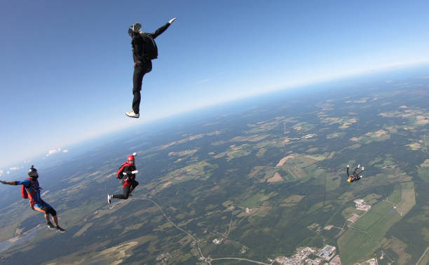 istock Skydivers fall through clear skies, aerial flight 1176962640