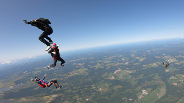 istock Skydivers fall through clear skies, aerial flight 1176962654