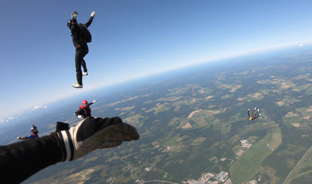 istock Skydivers fall through clear skies, aerial flight 1176963003