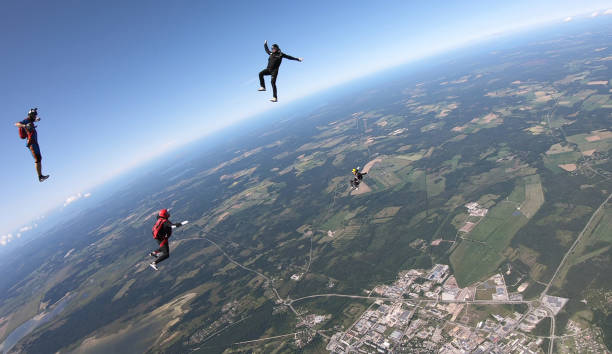 istock Skydivers fall through clear skies, aerial flight 1176963089